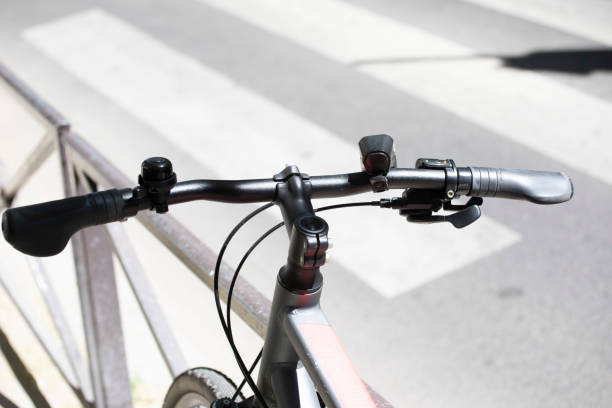 istock Close-up of bicycle handlebars by a zebra crossing 1413998785