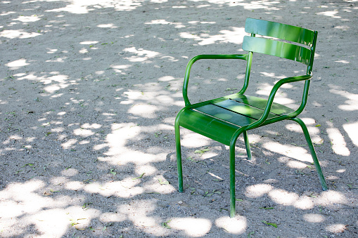 Green coloured garden chair in Jardin Des Tuileries, Paris in summer