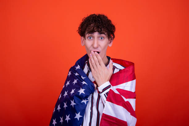 istock Young attractive guy with a flag posing in the studio. 1414002216