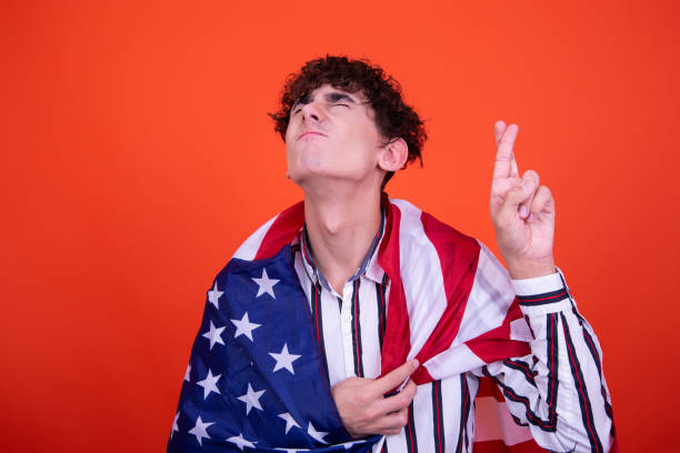 istock Young attractive guy with a flag posing in the studio. 1414002382