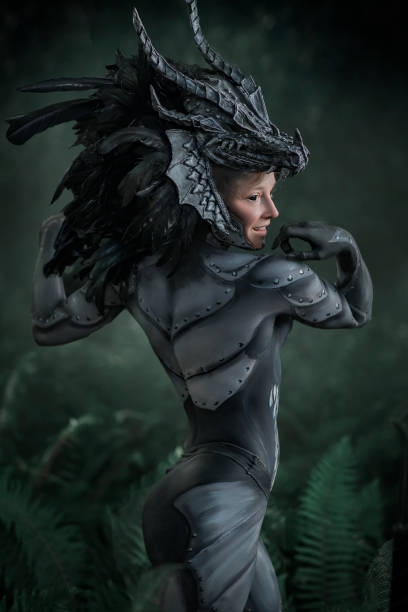 istock Dragon body paint on a beautiful female model in a forest 1414006122