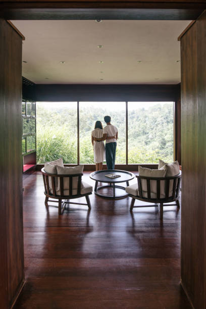 istock Couple in hotel room enjoying view from window 1414007130