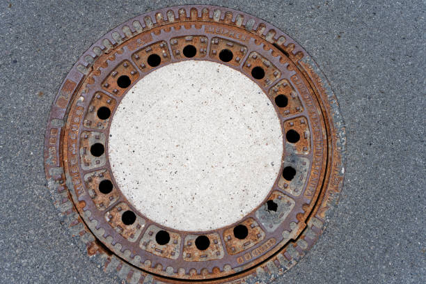 rosted manhole cover close up of a manhole cover sewer lid stock pictures, royalty-free photos & images