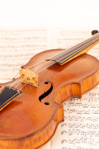 istock Baroque Violin with music sheets in the background 1414010510