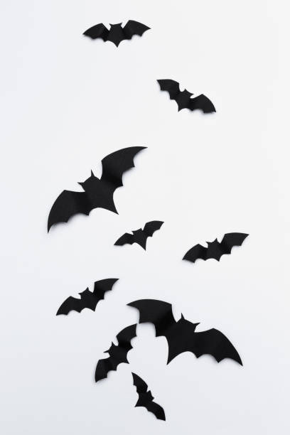 istock halloween and decoration concept - paper bats flying 1414010748