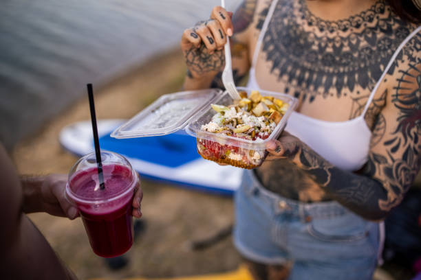 istock Caucasian couple, eating and drinking, while camping near lake 1414012139