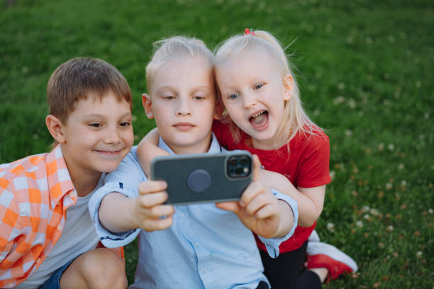 istock cute funny children shooting selfie with smartphone 1414013452