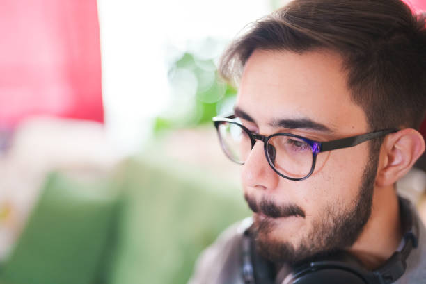 istock Young man watching a video with facial expressions 1414013479