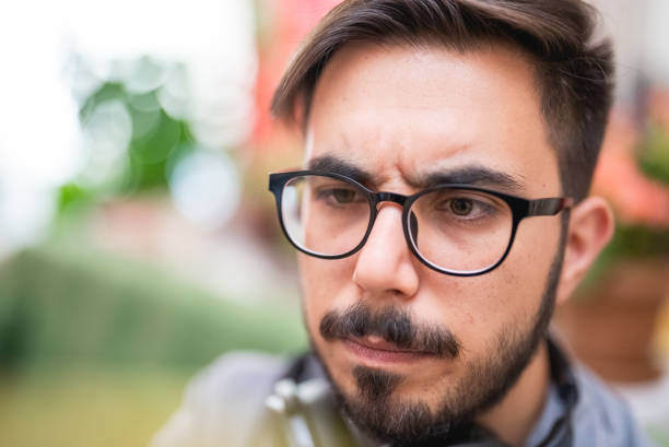 istock Young man with eyeglasses frowning 1414013494