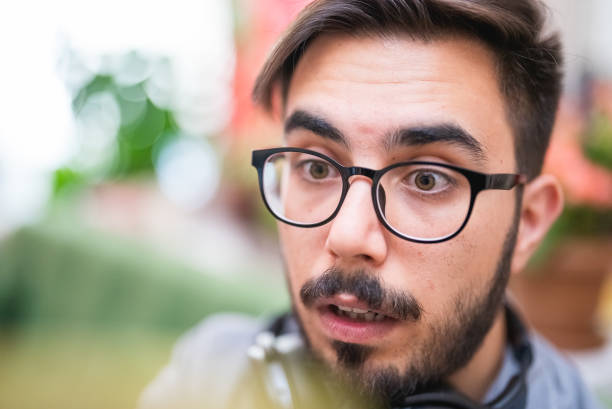 istock Young man watching a video with surprised facial expressions 1414013525