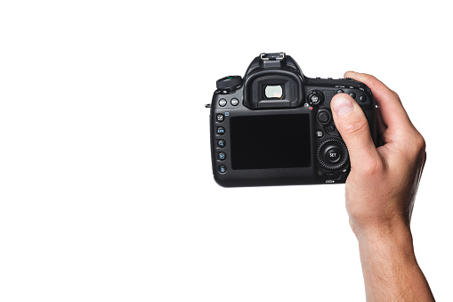 Photo camera in hand isolated on white background