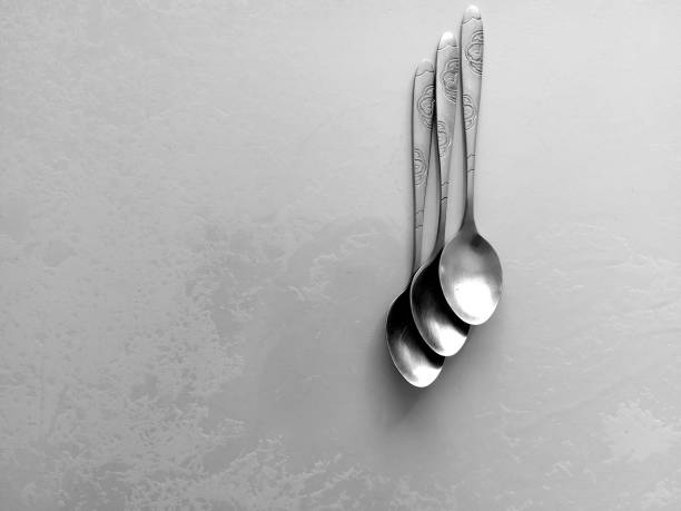 teaspoons on the table in black and white