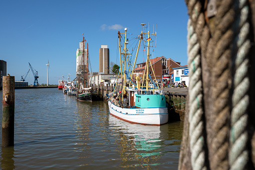 Husum, Germany - May 8, 2022: Harbor of Frisian city Husum on a sunny day during springtime on May 8, 2022 in North Frisia, Germany
