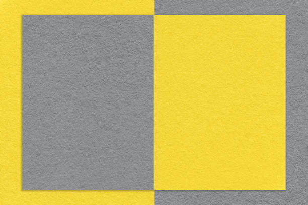 istock Texture of yellow and gray paper background with geometric shape and pattern, macro. Structure of craft grey cardboard 1414014323