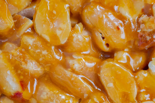Close up, top view: caramelized nuts fried in honey - orange granola peanut bar - Gozinaki: macro. Traditional Georgian cuisine, gastronomy, oriental sweet and food concept