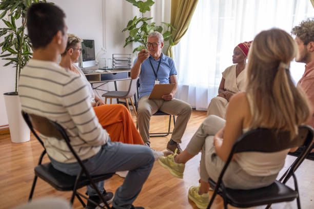 istock Male psychotherapist leading a group support therapy 1414015526