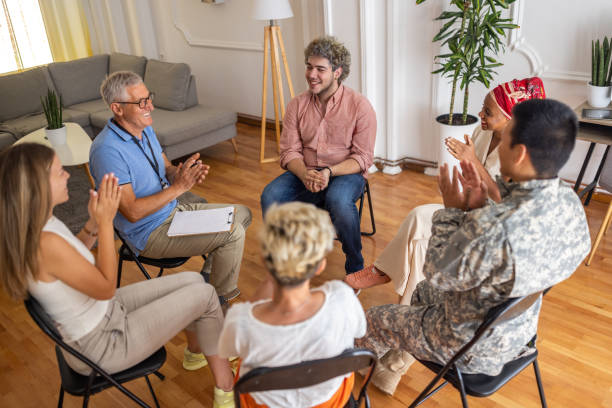 istock Multiracial people applauding during support group psychotherapy 1414015843