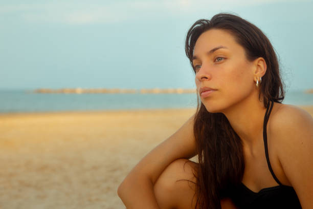 istock Young woman portrait at beach 1414016460