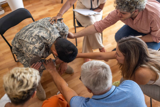 istock Multiracial people consoling the soldier during group therapy 1414018113