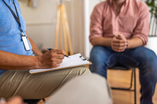 istock Male psychotherapist leading a group therapy 1414018319