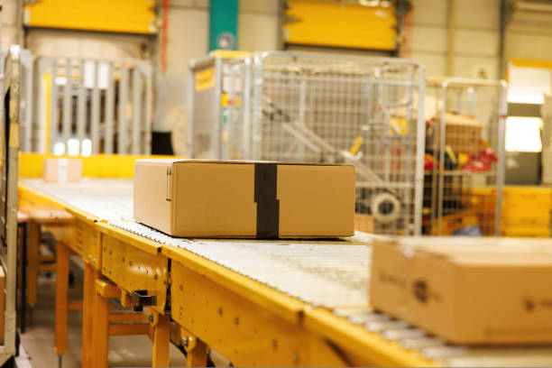istock Box on conveyor roller. Delivery service, distribution warehouse and parcels transportation system. 1414018526