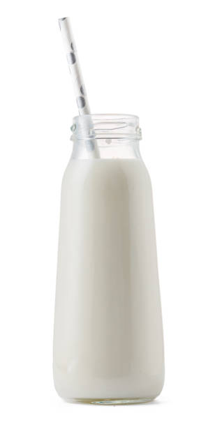 istock Glass cup of milk with a straw isolated on white 1414019965