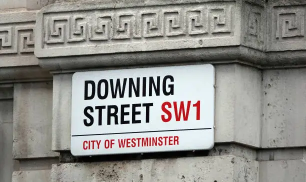 Downing Street sign in the wall in Westminster, London, UK.