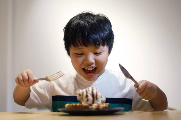 istock Boy enjoying delicious waffles ice-cream 1414022998