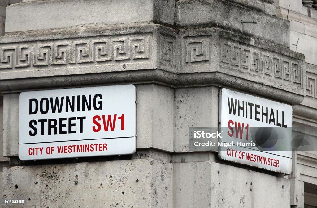 Downing Street and Whitehall signs on the corner where both streets meet in London, UK. Downing Street and Whitehall signs in Westminster, London, UK. 10 Downing Street Stock Photo