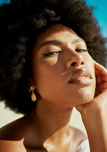 Beauty, skin and attractive face of lady with afro. Natural hair and five minute daily makeup looks for young woman tutorial. Sustainable skincare and cosmetics for the everyday woman on the go.