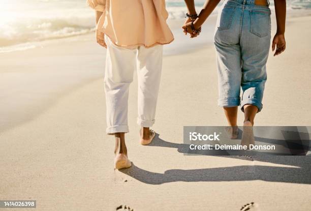 Closeup Couple Walking Barefoot On A Sandy Beach And Enjoying Fresh Air Together On Vacation Low View Of Husband And Wife Taking A Slow Romantic Walk While Holding Hands While On Summer Holiday Stock Photo - Download Image Now