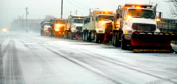 istock Snow Plows in Severe Blizzard Preparing for Storm 1414027591