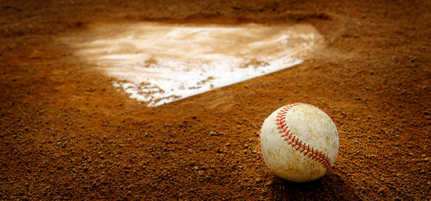 Old Leather Baseball on Field by Home Plate or Base Old leather baseball on dirt field by home plate or a base home plate stock pictures, royalty-free photos & images