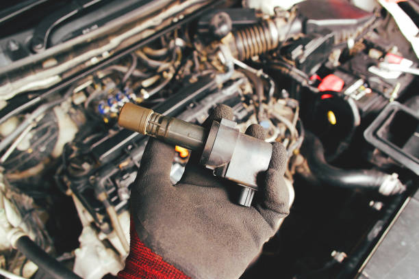 istock A mechanic hand holds an ignition coil for a spark plug 1414027841