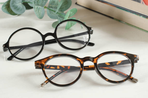 istock Stylish female glasses on white wooden table 1414027949