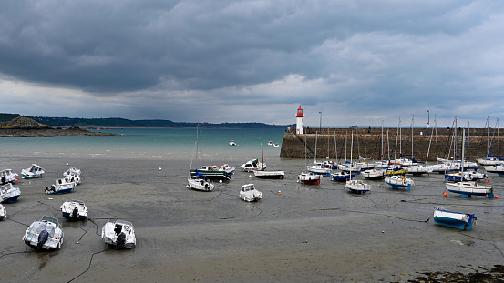 The walled city of Saint-Malo, France, with granite residential buildings protruding above the rampart and the Mole beach at the foot of the fortifications, seen from the breakwater.