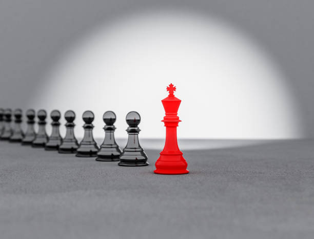 istock A red chess king stands at the front leading a black chess piece, 3d illustration 1414031212