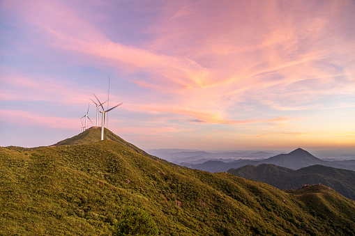 Aerial photography of alpine wind farm at sunset