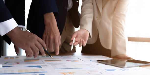 istock Team business people hand pointing at business document during discussion at meeting. 1414033656