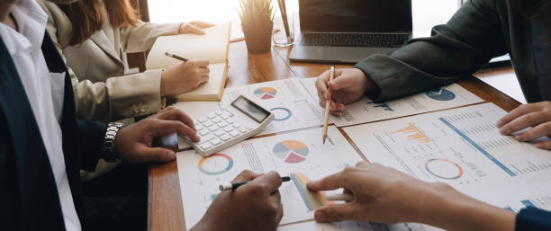 istock Business team analyzing income charts and graphs with modern laptop computer. Close up.Business analysis and strategy concept. 1414034552