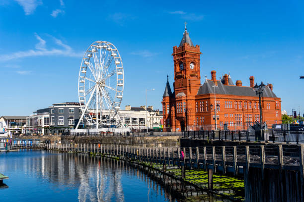 Cardiff United Kingdom Historical Red Brick Pierhead Building with Ferris Wheel in the background stock photo