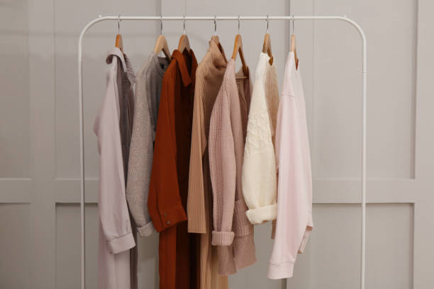 istock Rack with different stylish clothes near grey wall 1414036125