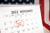 istock Election day concept. Desk calendar with November 8 2022 marked in red and USA flag at background 1414036291