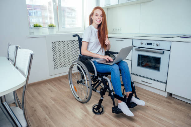 istock redhaired ginger woman in wheelchair at kitchen 1414036365