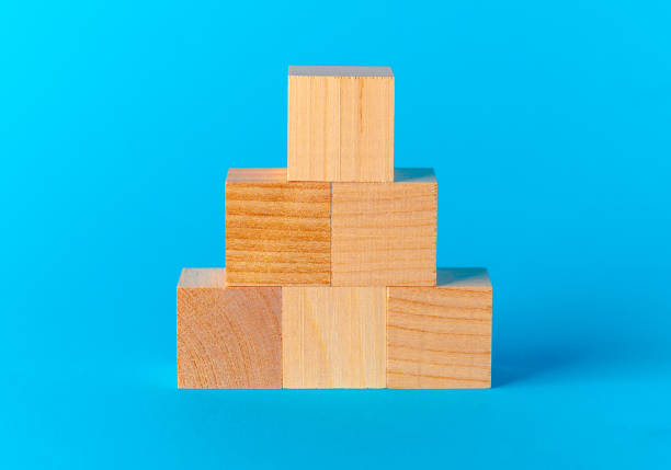 istock Toy wooden blocks on blue background front view 1414036830