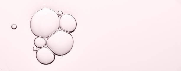 istock Pink texture of cosmetic serum with bubbles. Copy space. 1414037092