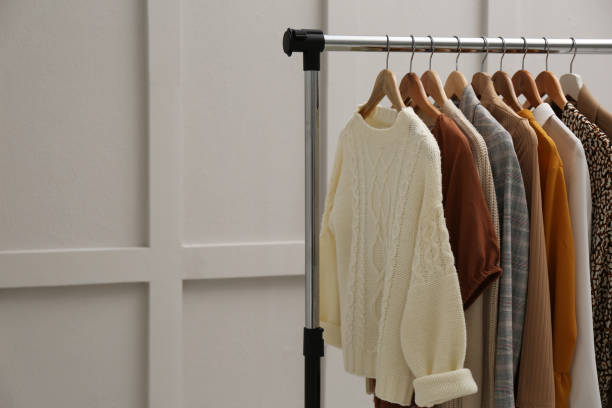 istock Rack with different stylish clothes near grey wall. Space for text 1414038618
