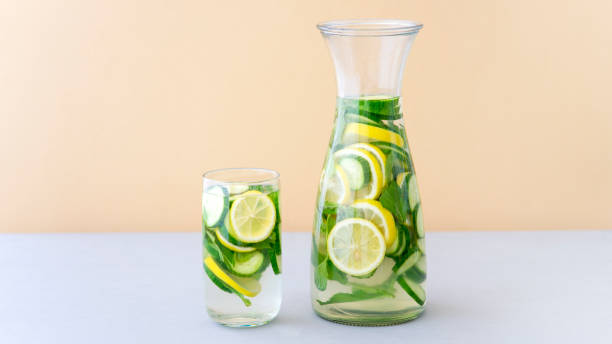 Detox Water Infused with Sliced Lemon, Cucumber and Sprigs of Mint. Copy Space on the Right. stock photo