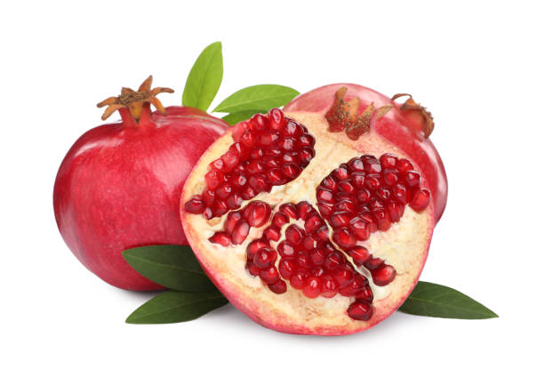 istock Ripe pomegranates with green leaves on white background 1414039656