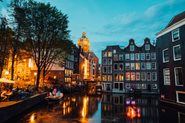 Amsterdam city lights and traffic on canals at dusk